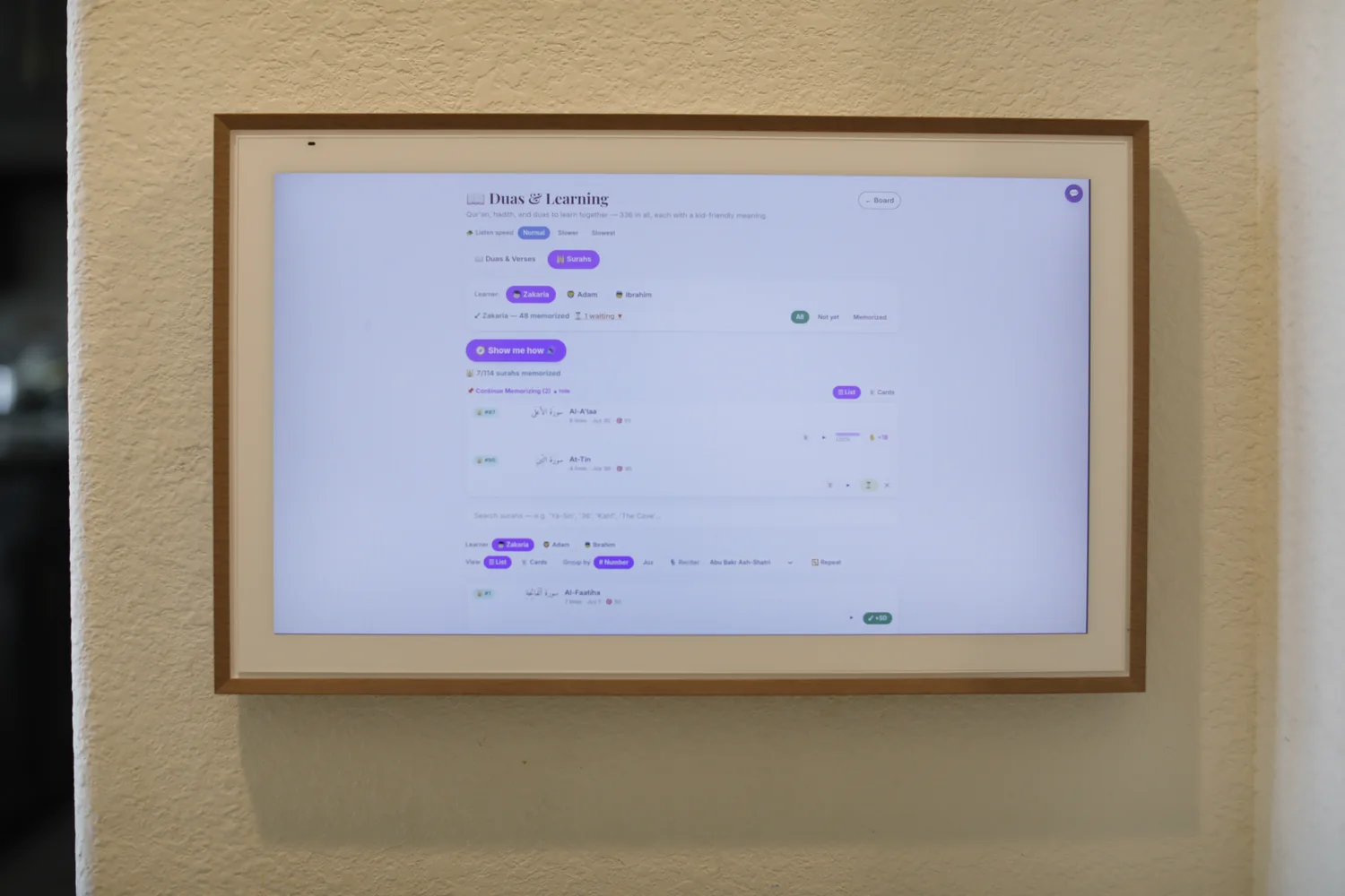 The AdabStars board mounted on the wall of Yasar's home, showing the surah memorization tracker for his three sons